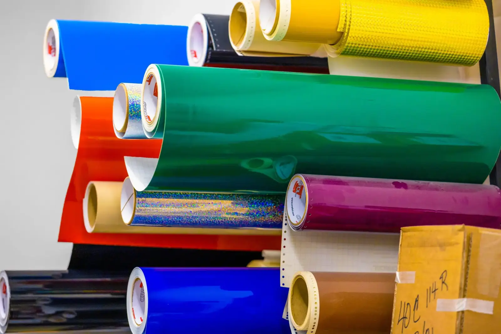 Rolls of durable colored vinyl used for equipment graphics at Signs Limited