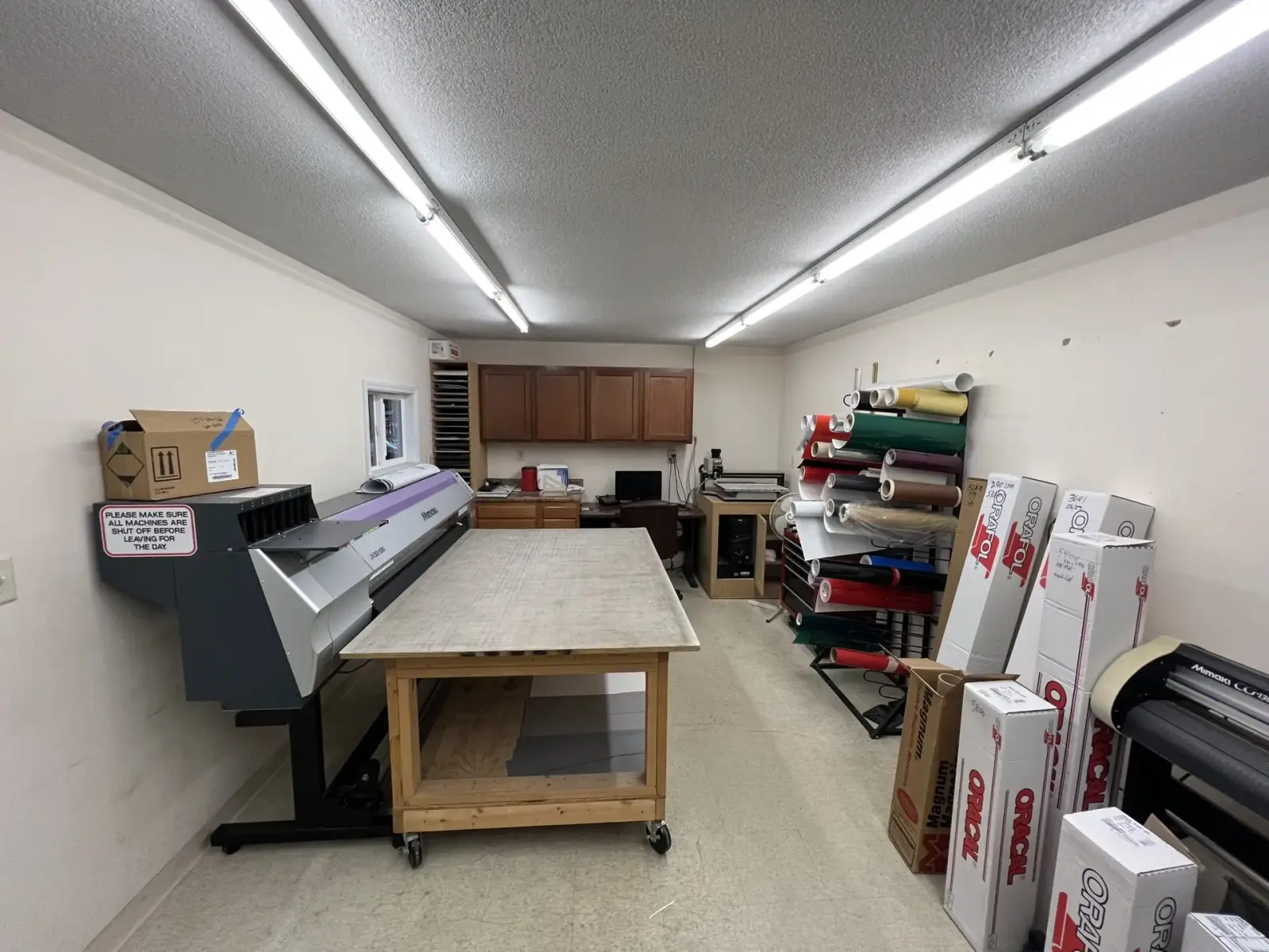 Design and production room at Signs Limited with printers and vinyl stock