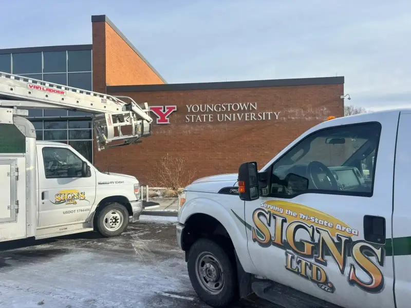 Signs Limited trucks at a completed university sign project